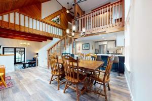 a dining room and kitchen with a wooden table and chairs at New England Treasure in North Conway