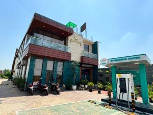 a building with motorcycles parked in front of it at Atmosphere Hotel & Restaurant in Alīgarh +4 photos