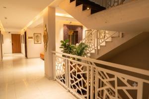 a hallway of a house with a staircase at Hotel Madhuram Shivpuri MP in Shivpurī