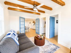 a living room with a couch and a ceiling fan at Wild Cove Nook in Twillingate