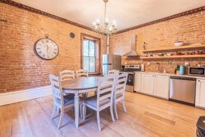 a kitchen with a table and chairs and a clock at 406 Canyon Rd #1 in Ogden