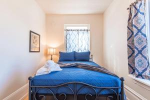 a bedroom with a blue bed with a window at 406 Canyon Rd #1 in Ogden