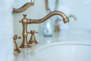 a bathroom sink with a brass faucet at 406 Canyon Rd #1 in Ogden +19 photos