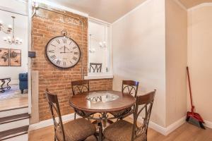a dining room with a table and a clock on a wall at 406 Canyon Rd #2 in Ogden