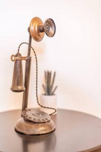 an old fashioned desk lamp with a bell on a table at 406 Canyon Rd #2 in Ogden