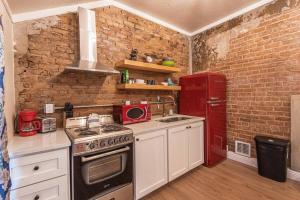 a kitchen with a stove and a red refrigerator at 406 Canyon Rd #2 in Ogden