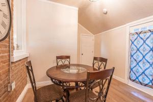 a dining room with a table and chairs and a clock at 406 Canyon Rd #2 in Ogden +12 photos