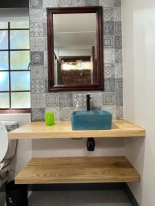 a bathroom with a sink and a mirror at The Unexpected at Cannon Rocks in Cannon Rocks