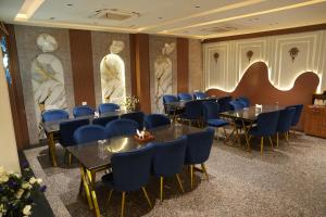 a dining room with tables and chairs and statues at Hotel Madhuram Shivpuri MP in Shivpurī