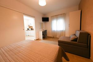 a bedroom with a bed and a couch at Apartment Sanja in Zadar