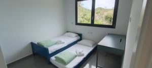 a small room with two beds and a window at Caribe in Platja d'Aro +44 photos