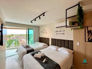 a hotel room with two beds and a window at Fortaleza Sul Prime By Holiday Stays in Fortaleza