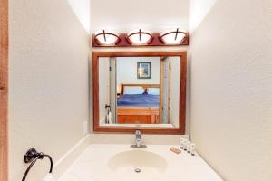 a bathroom with a sink and a mirror at Crestview 48 in Mammoth Lakes +108 photos