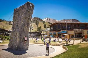 a group of people playing on a rock wall at Crestview 48 in Mammoth Lakes