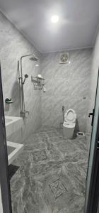 a bathroom with a shower and a toilet in it at Coco Retreat in Tân Phú