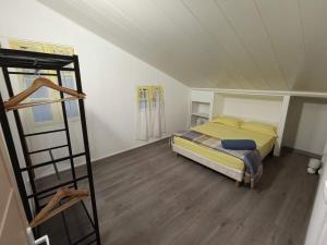 a bedroom with a bed and a ladder in a room at La grande découverte 2 in Cilaos