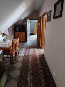 a kitchen and dining room with a table and chairs at Lipowy Dworek Pensjonat in Staroguby +10 photos