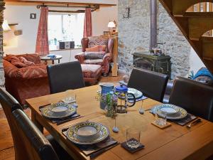 a wooden table with chairs and a dining room at The Old Barn in Abbotsham