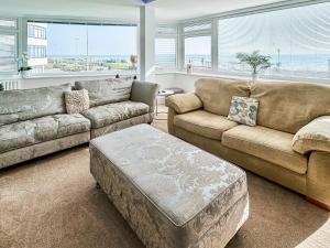a living room with a couch and a coffee table at The Beach House in Worthing