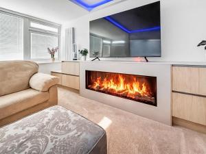 a living room with a fireplace and a couch at The Beach House in Worthing