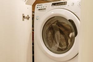 a white washing machine sitting in a bathroom at Alkyoni Samos Maisonette in Mytilinioí