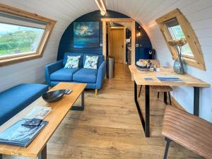 a tiny house with a blue couch and a table at Duich - Uk50716 in Kirkton