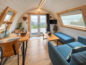 a living room with a couch and a table at Duich - Uk50716 in Kirkton +8 photos