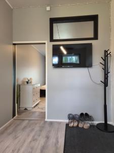 a living room with a tv on the wall at Your loft in Seinäjoki +5 photos