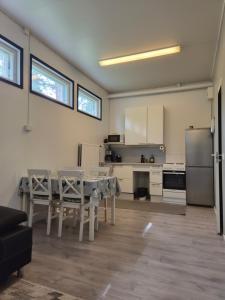 a kitchen and dining room with a table and a refrigerator at Your loft in Seinäjoki