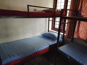 a bedroom with two bunk beds and a window at CK Enclave in Tripunittura