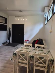 a room with a table and two chairs and a couch at Your loft in Seinäjoki