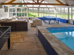 a swimming pool with a patio and a pool table at Lily Pad 7 - Uk43916 in Nassington