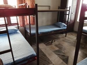 a room with three bunk beds in a room at CK Enclave in Tripunittura