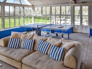 a couch in a room with a ping pong table at Lily Pad 7 - Uk43916 in Nassington