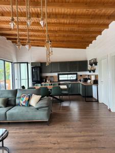 a living room with a couch and a kitchen at Vila KEY-A in Borsh