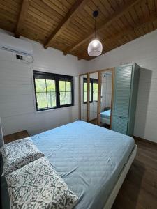 a bedroom with a large bed and a window at Vila KEY-A in Borsh