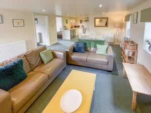 a living room with a couch and a table at Lily Pad 9 - Uk43919 in Nassington