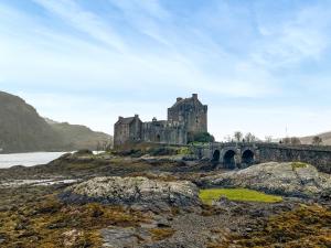 an old castle on a hill with a bridge at Totaig - Uk50717 in Kirkton