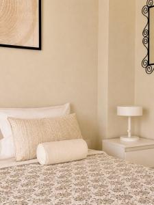a bedroom with a bed with a pillow and a lamp at Agapidis Apartment in Hanioti