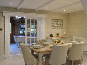 a dining room with a wooden table and chairs at Tennox Farm House - Uk36254 in Kilbirnie +13 photos