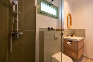 a bathroom with a shower and a toilet and a sink at Asini deluxe suite 6, with rooftop terrace and breathtaking views in Asíni +45 photos