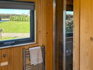a bathroom with a window and a towel on a chair at The Welbury - Ukc9285 in Brompton +1 photo