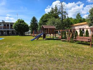 a playground with a slide in a yard at Oaza Pieczyska in Koronowo