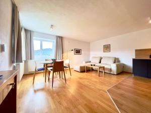a living room with a couch and a table at Hotel Berghof in Seefeld in Tirol