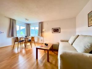 a living room with a couch and a table at Hotel Berghof in Seefeld in Tirol
