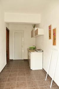 an empty room with a kitchen with a counter at Paradise studios in Nikiti