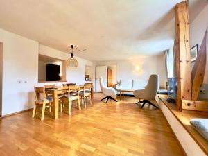 a dining room and living room with a table and chairs at Hotel Berghof in Seefeld in Tirol