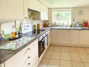 a kitchen with white cabinets and a counter top at Lily Pad 2 - Uk43901 in Nassington