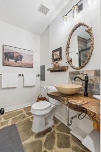 a bathroom with a sink and a toilet at 3BR Cabin Sleeps 10 Fenced Yard in Oklahoma City +45 photos