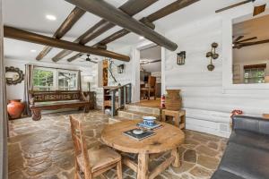 a living room with a table and a couch at 3BR Cabin Sleeps 10 Fenced Yard in Oklahoma City